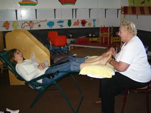 Tina Thatcher being given a reflexology treatment by Mary Gilhooly